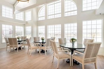 A dining room with a table and chairs
